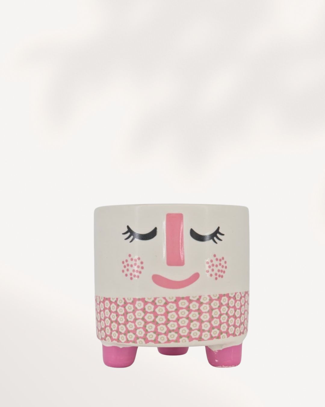 A small, modern ceramic Rosie Pot with a white, rosy pink, and charcoal gray finish, perfectly sized for a 2.5-inch indoor plant on a desk or windowsill.