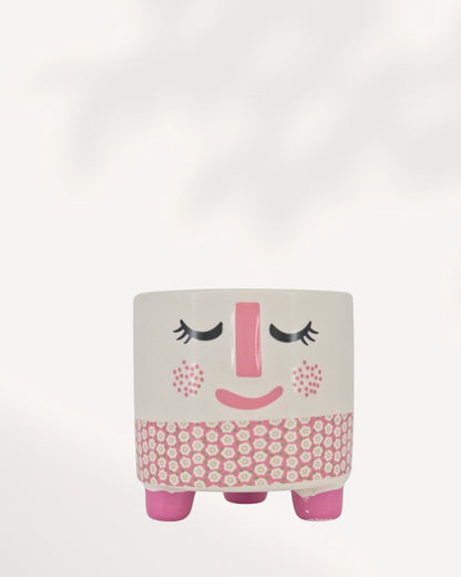 A small, modern ceramic Rosie Pot with a white, rosy pink, and charcoal gray finish, perfectly sized for a 2.5-inch indoor plant on a desk or windowsill.